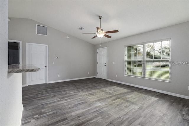 empty room featuring dark hardwood / wood-style floors, ceiling fan, and lofted ceiling