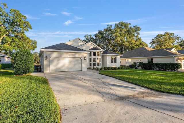 ranch-style home featuring a garage and a front yard