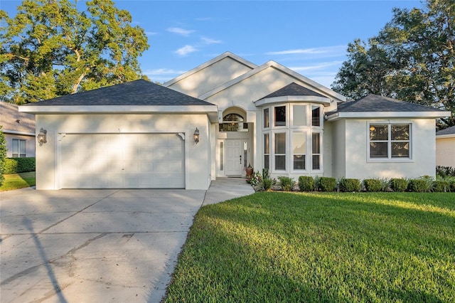 ranch-style house featuring a front yard and a garage