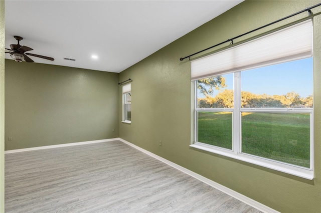 empty room featuring ceiling fan and light hardwood / wood-style floors