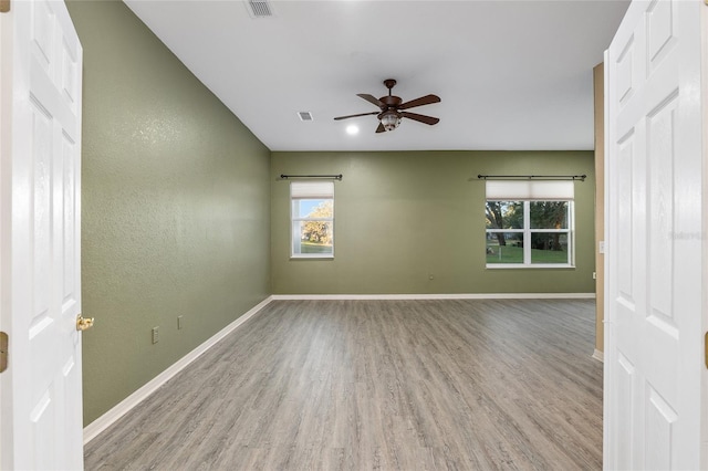 unfurnished room featuring ceiling fan and light wood-type flooring