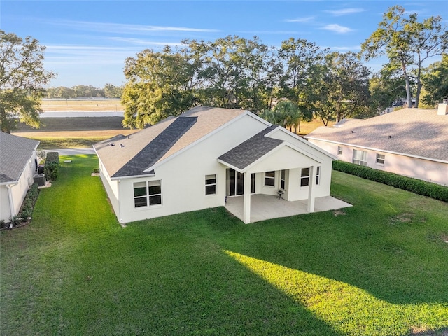 back of house featuring a yard and a patio