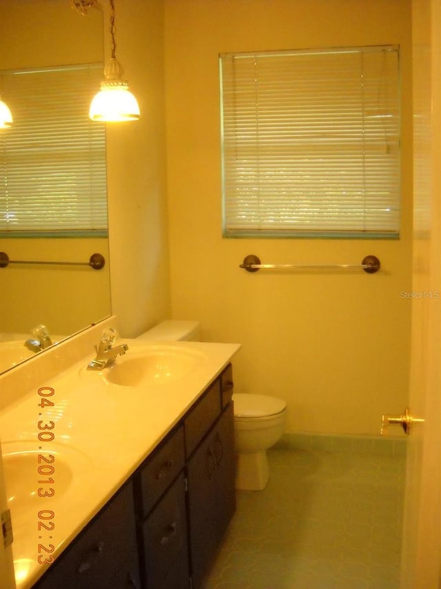 bathroom featuring tile patterned floors, vanity, and toilet