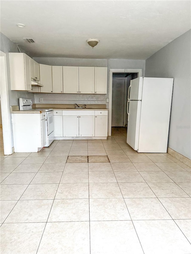 kitchen with sink, white appliances, tasteful backsplash, and light tile patterned flooring