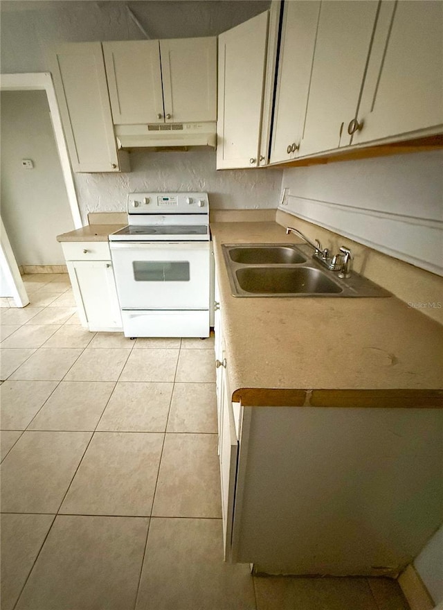 kitchen with white range with electric stovetop, light tile patterned floors, and sink