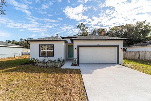 view of front of home featuring a front lawn and a garage