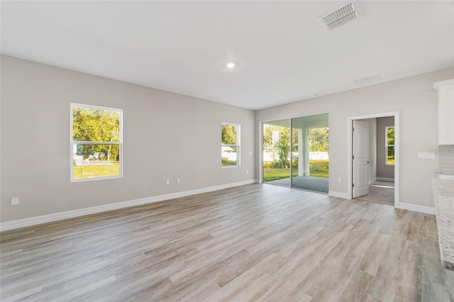 empty room featuring plenty of natural light and light wood-type flooring