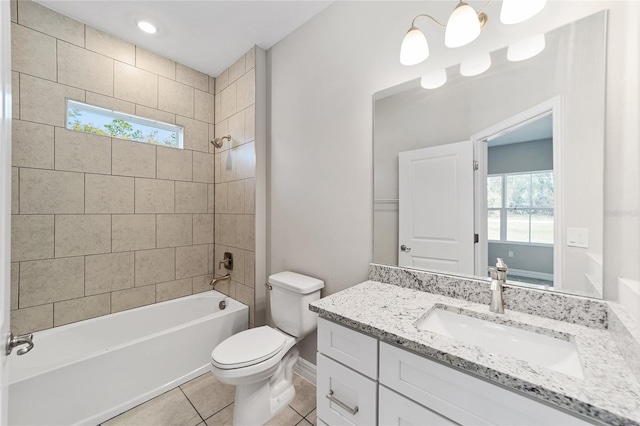 full bathroom featuring tile patterned floors, a wealth of natural light, tiled shower / bath combo, and toilet