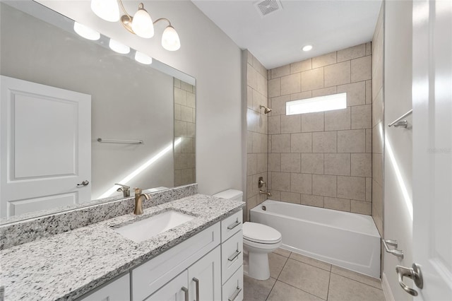 full bathroom featuring tile patterned floors, toilet, vanity, and tiled shower / bath