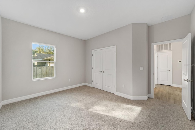 unfurnished bedroom with carpet floors and a closet