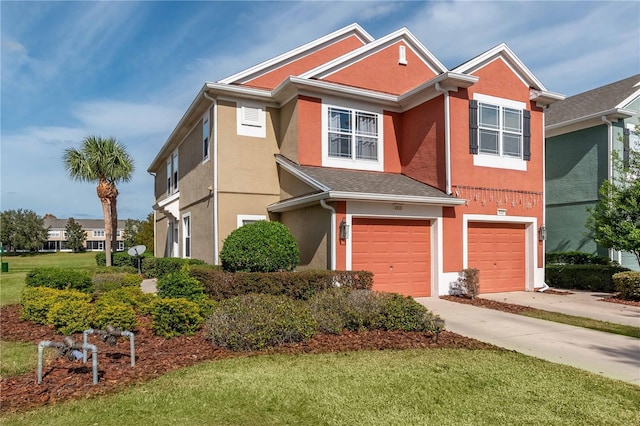 view of front of home with a front yard and a garage