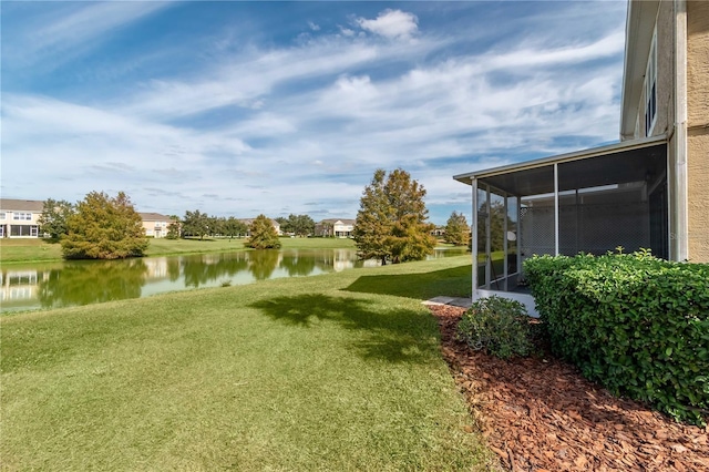 view of yard with a water view and a sunroom