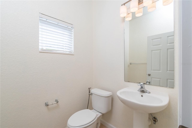 bathroom featuring sink and toilet