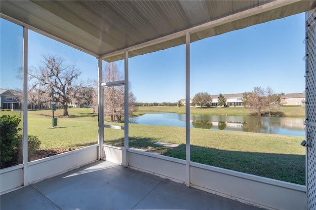 unfurnished sunroom featuring a water view