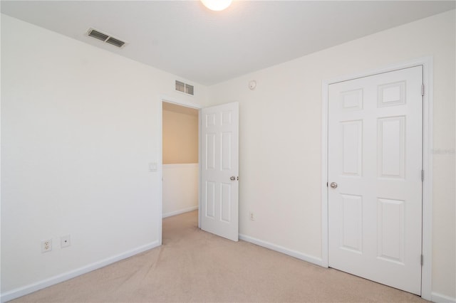 unfurnished bedroom featuring light colored carpet