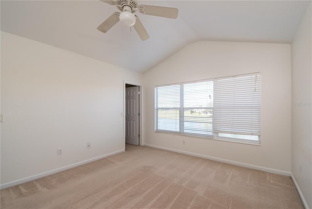 carpeted spare room with vaulted ceiling and ceiling fan