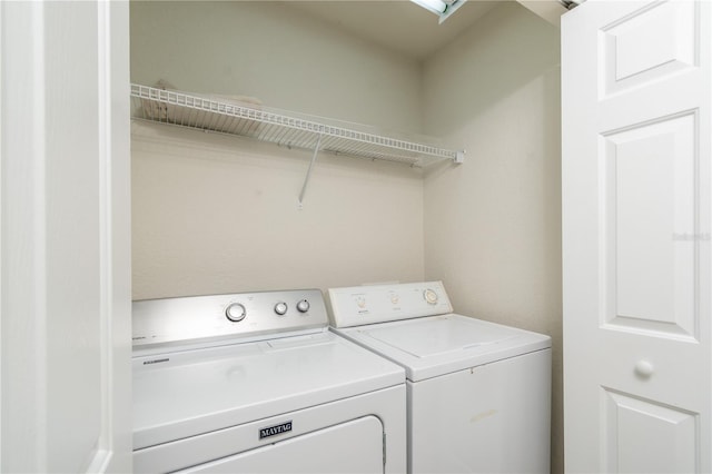 clothes washing area with separate washer and dryer