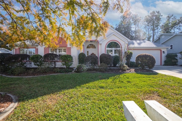 view of front of home with a front lawn and a garage