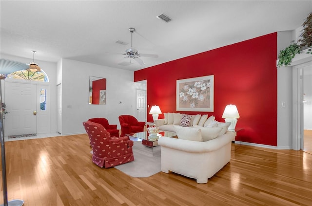 living room with hardwood / wood-style floors and ceiling fan