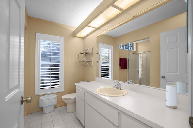 bathroom featuring tile patterned flooring, plenty of natural light, a shower with door, and vanity