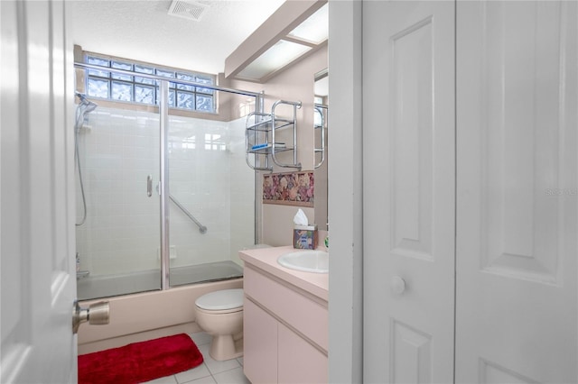 full bathroom with toilet, tile patterned flooring, vanity, and combined bath / shower with glass door