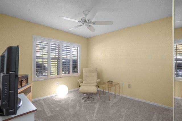 sitting room featuring a wealth of natural light, carpet floors, and ceiling fan