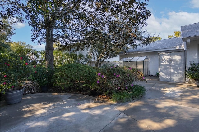 view of patio with an outbuilding