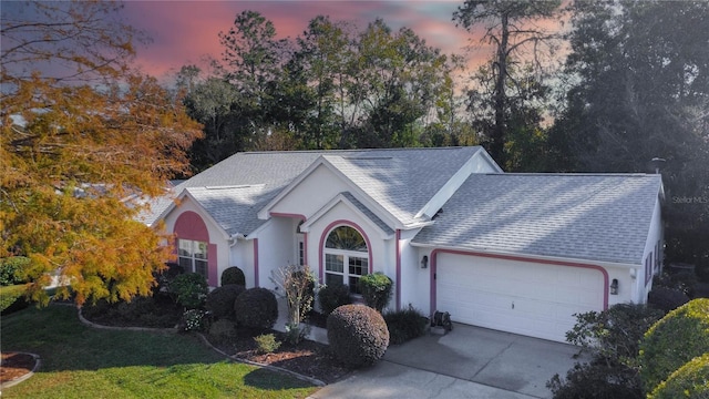 single story home featuring a yard and a garage