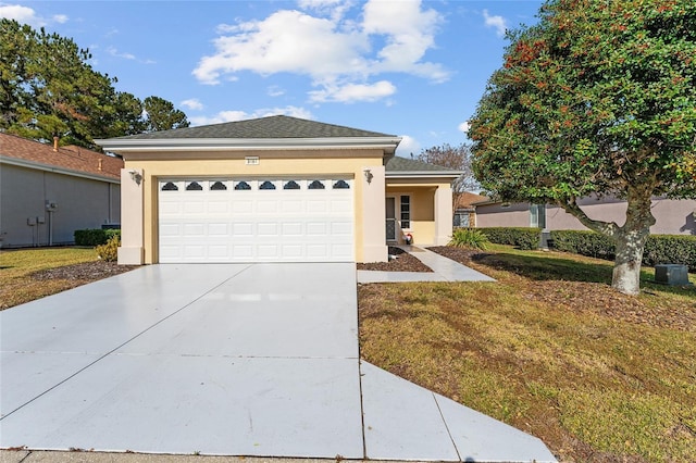 view of front of property featuring a garage and a front lawn