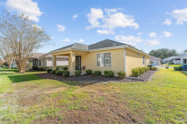 ranch-style house featuring central AC unit and a front lawn