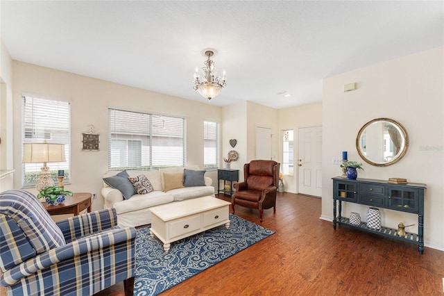 living room featuring dark hardwood / wood-style flooring and a chandelier