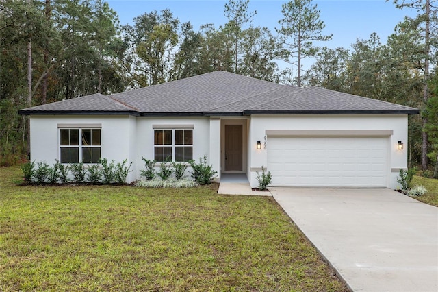 view of front of home with a front lawn and a garage