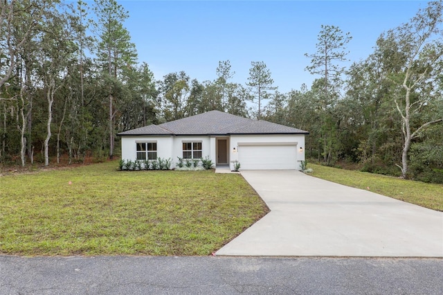 view of front of home with a garage and a front lawn