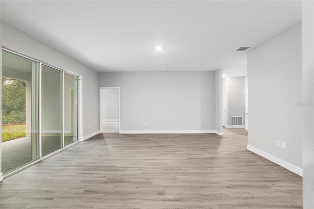 empty room with light hardwood / wood-style flooring