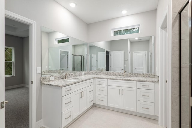 bathroom featuring vanity and an enclosed shower