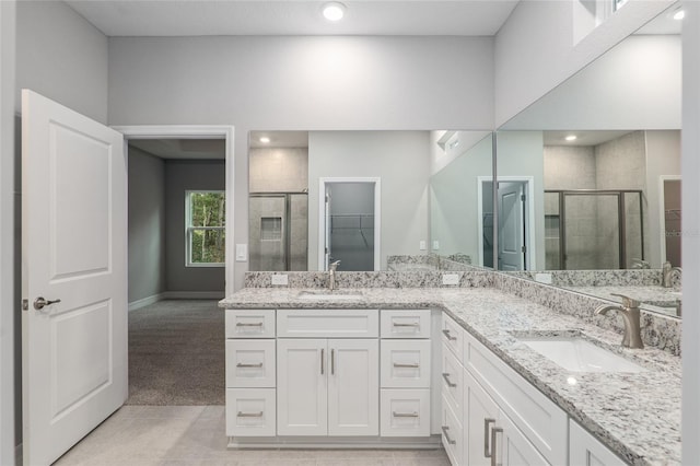 bathroom with tile patterned floors, vanity, and walk in shower