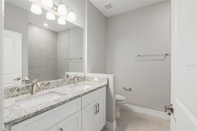 bathroom with tile patterned floors, vanity, and toilet