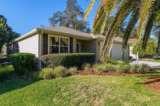 ranch-style home featuring a garage and a front lawn