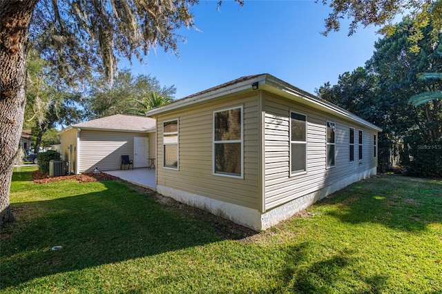 view of property exterior with a patio area, a yard, and cooling unit