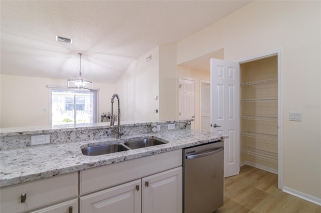 kitchen with white cabinets, sink, hanging light fixtures, stainless steel dishwasher, and light wood-type flooring