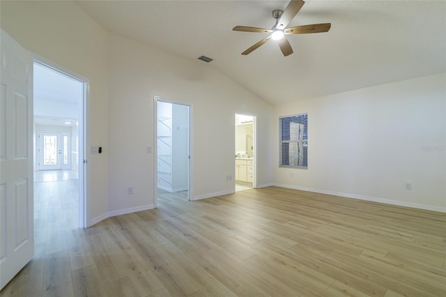 empty room featuring light hardwood / wood-style flooring, ceiling fan, and lofted ceiling