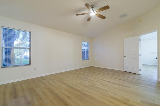 empty room with ceiling fan, light hardwood / wood-style flooring, and lofted ceiling