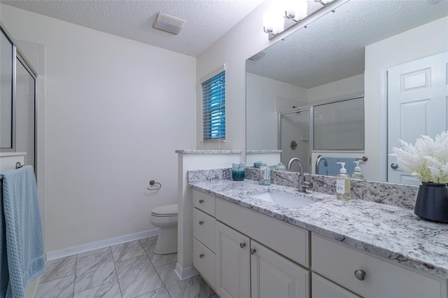 bathroom featuring vanity, toilet, a textured ceiling, and walk in shower