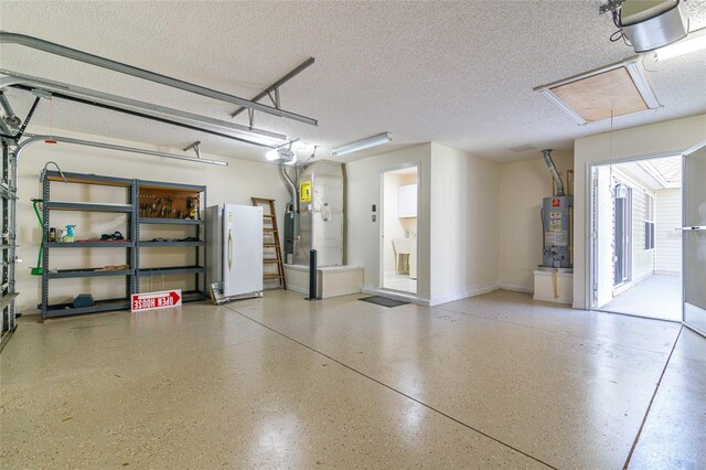 garage featuring water heater, a garage door opener, and white refrigerator