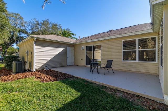 back of property with a patio area and central air condition unit