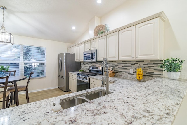 kitchen with stainless steel appliances, tasteful backsplash, light hardwood / wood-style floors, vaulted ceiling, and decorative light fixtures