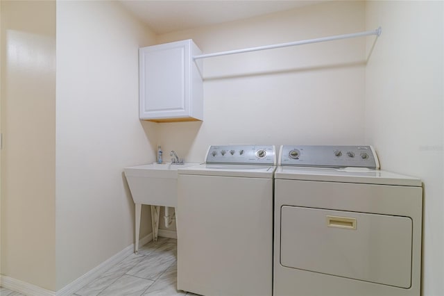 laundry area featuring cabinets and separate washer and dryer