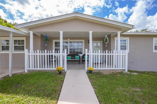 doorway to property featuring covered porch