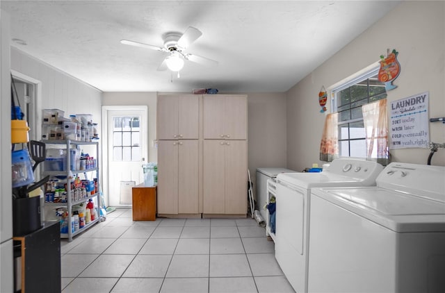 washroom featuring ceiling fan, cabinets, light tile patterned floors, and washing machine and clothes dryer