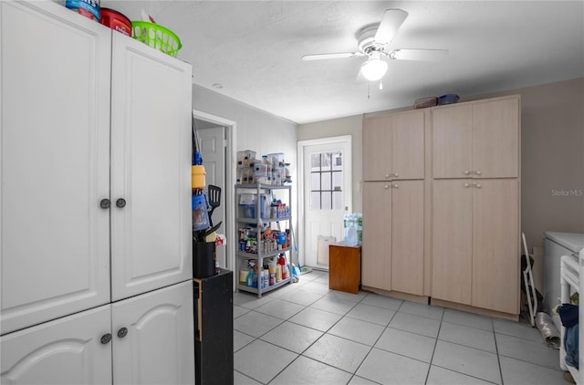 kitchen with ceiling fan, light tile patterned flooring, and light brown cabinetry